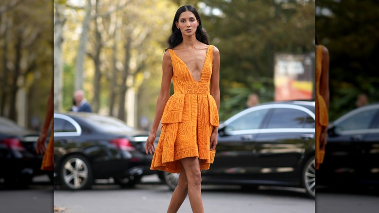 Woman wearing orange cocktail dress