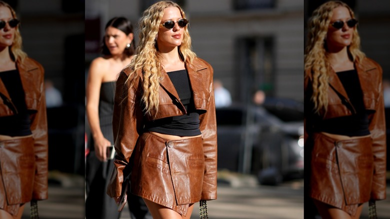 Woman wearing brown leather skirt and jacket