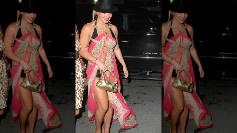 Britney Spears in a swimsuit cover-up and a fedora.