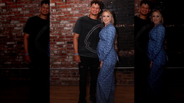 Pregnant Brittany Mahomes in maxi navy-blue suit