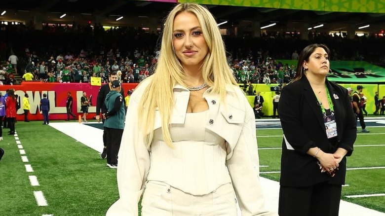 Brittany Mahomes wearing an all-white outfit to support her husband, Patrick Mahomes, at the 2025 Super Bowl