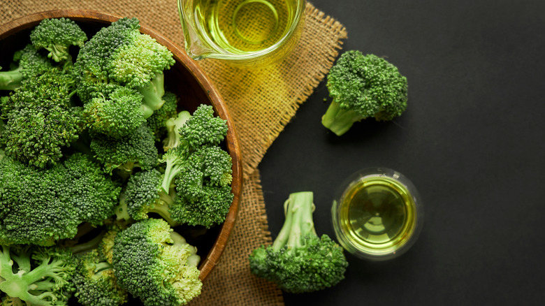 Bowl of broccoli with containers of oil