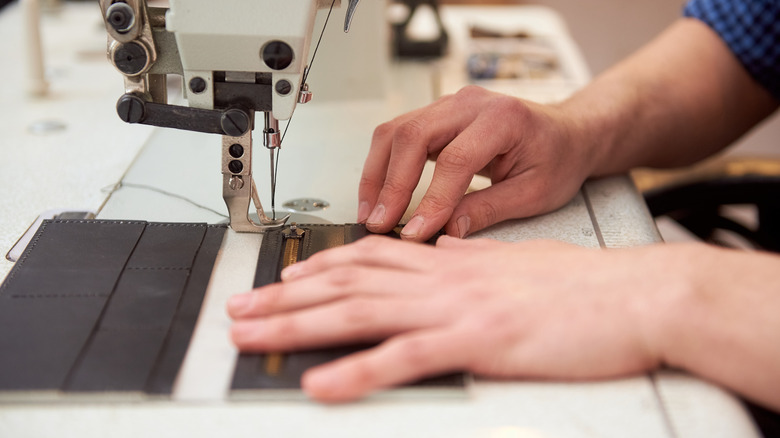 Person sewing a new zipper