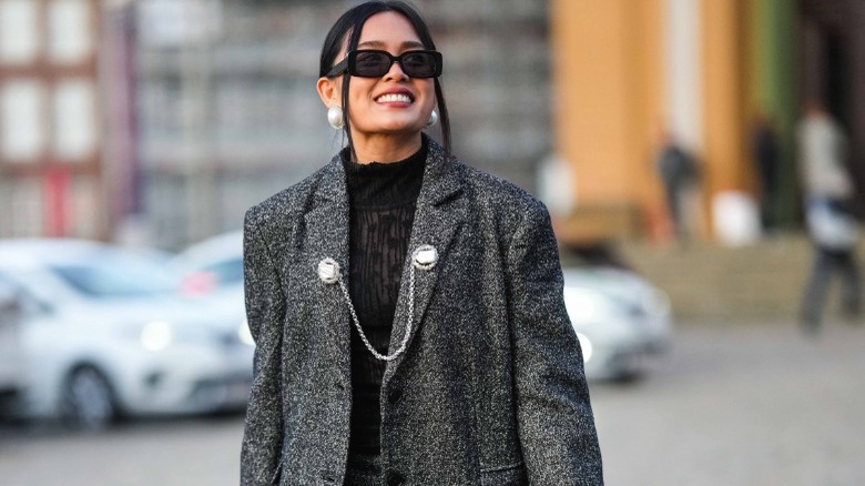 woman wearing two chain brooch