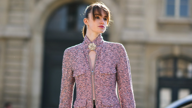 woman wearing gold brooch