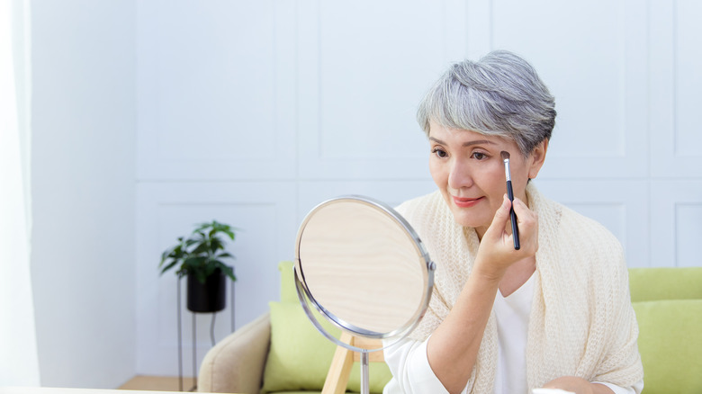 Woman applying eyebrow makeup