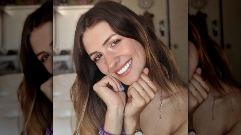 Woman with brown balayage smiling