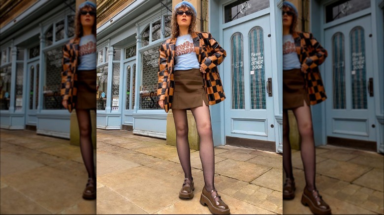 Woman wears brown skirt and blue vintage tee 