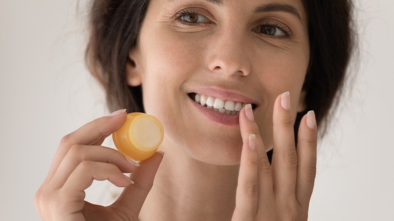 Woman applying lips scrub