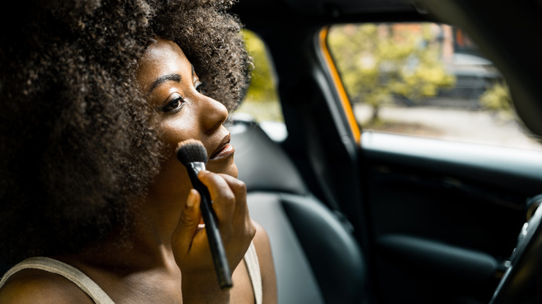 woman applying foundation with brush