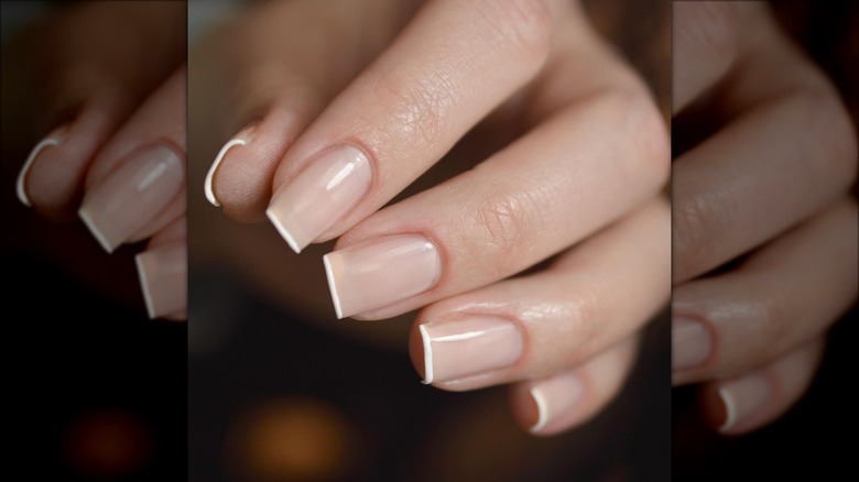 Hand with micro french sheer nails