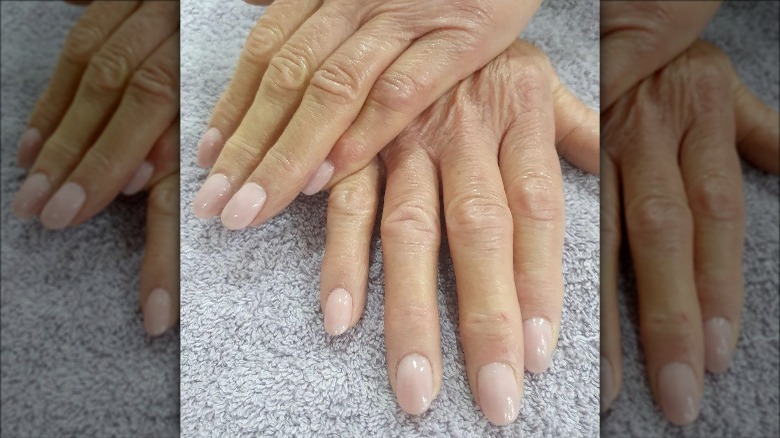 Hands with milky pink nails