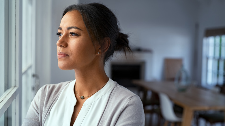 woman looking outside thinking 