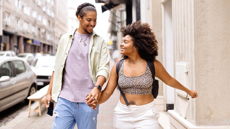 smiling couple walking in city