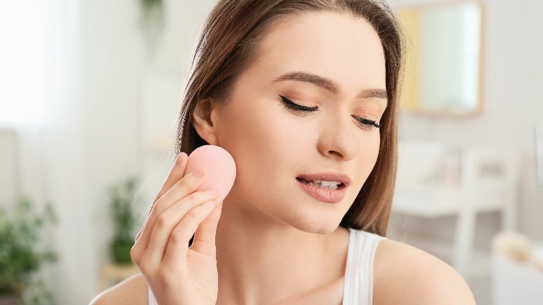 Woman applying foundation