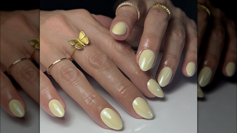 Almond-shaped yellow chrome nails