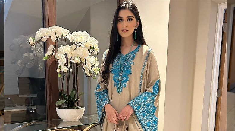 Woman poses in embroidered caftan