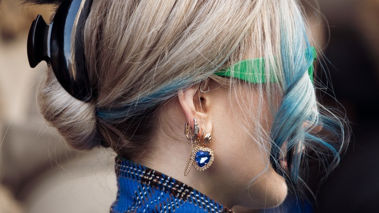 woman wearing blue gem earring