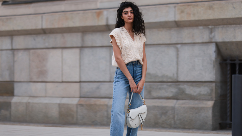 woman wearing sleeveless cable-knit sweater