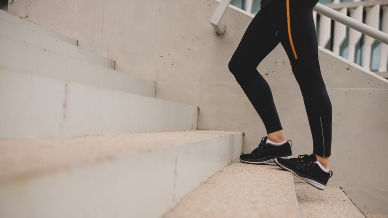 runner stretching on stairs