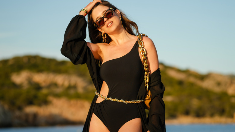 Claire Marnette wearing black swimsuit and belt
