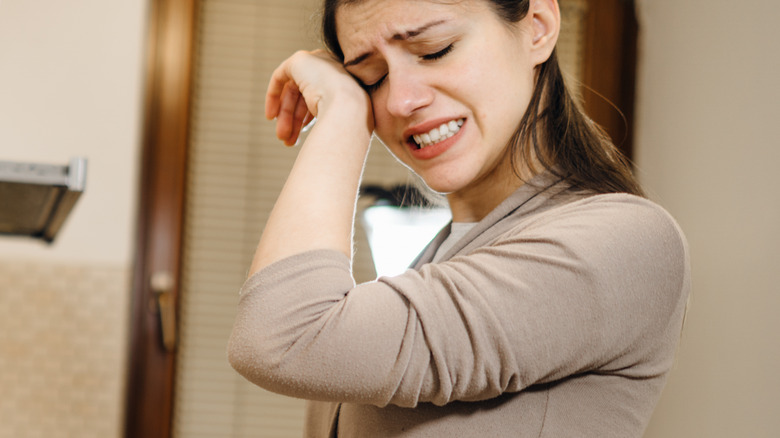 female crying in the kitchen