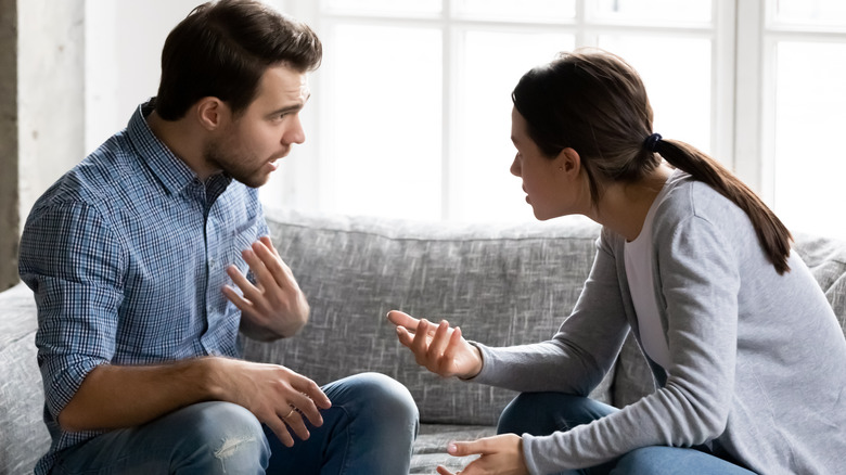 couple arguing on sofa