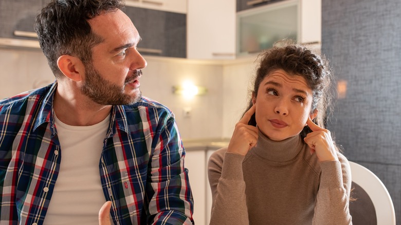 woman ignoring angry man