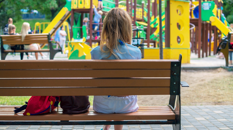 Mom on bench at playground