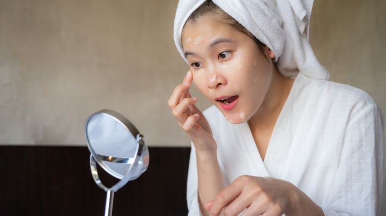 woman applying concealer