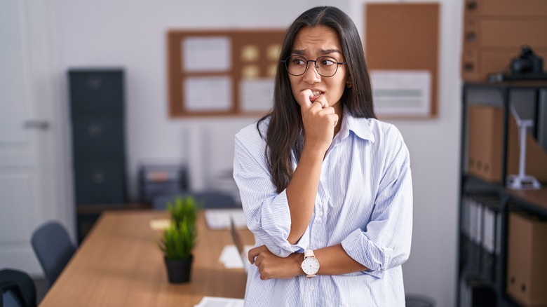 Anxious woman biting nails