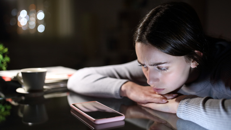 stressed woman looking at phone