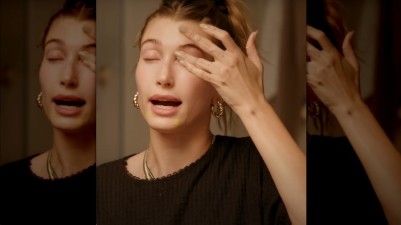 Hailey Bieber applying eye cream