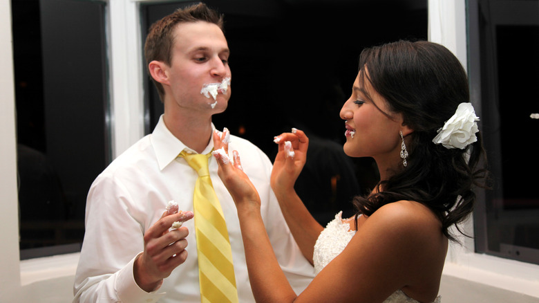 couple feed on wedding cake