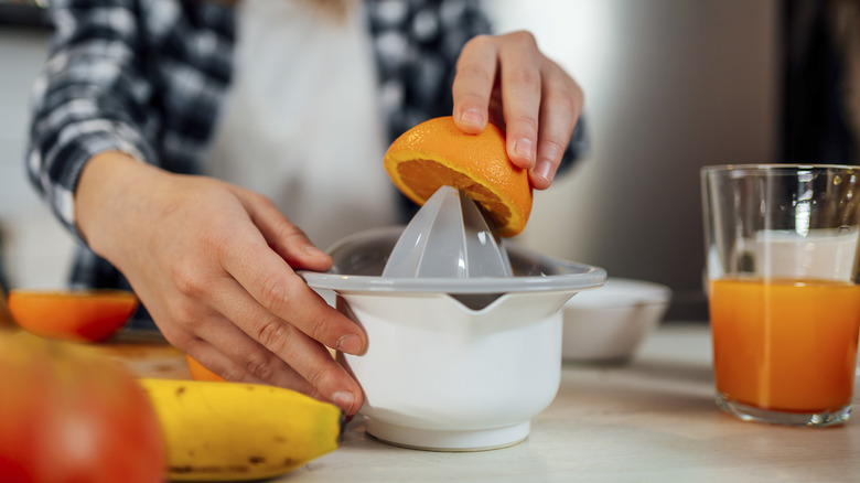 Woman making orange juice