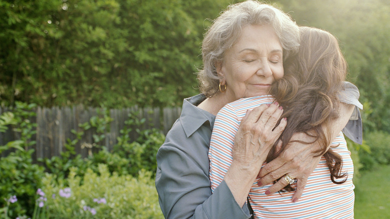 Woman hugs grandmother 