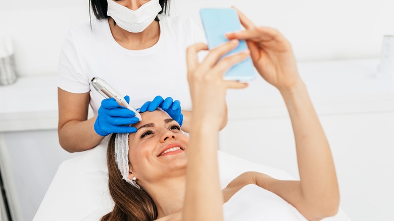 woman looking at microneedling results