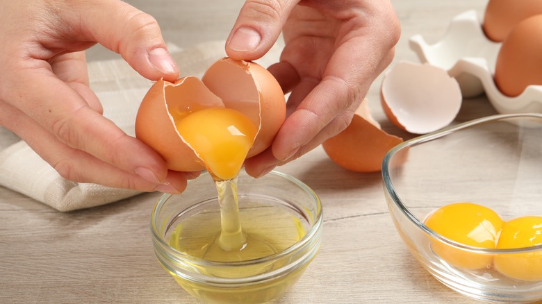 person cracking an egg