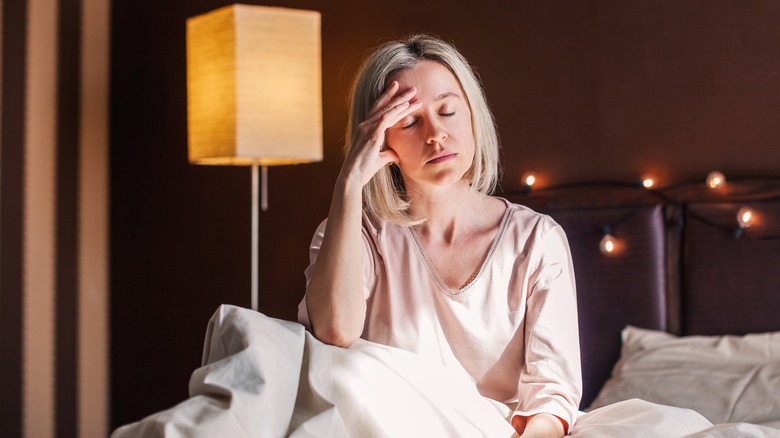 Woman thinking in bed