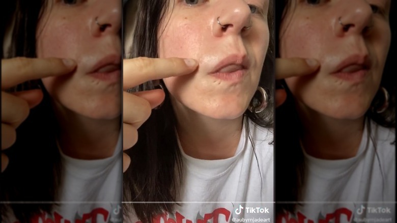 Woman points to pimple on TikTok