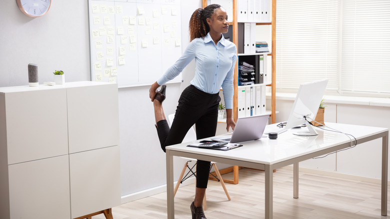 woman stretching at desk