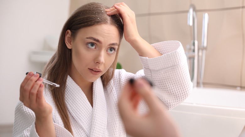 Girl inspecting her scalp