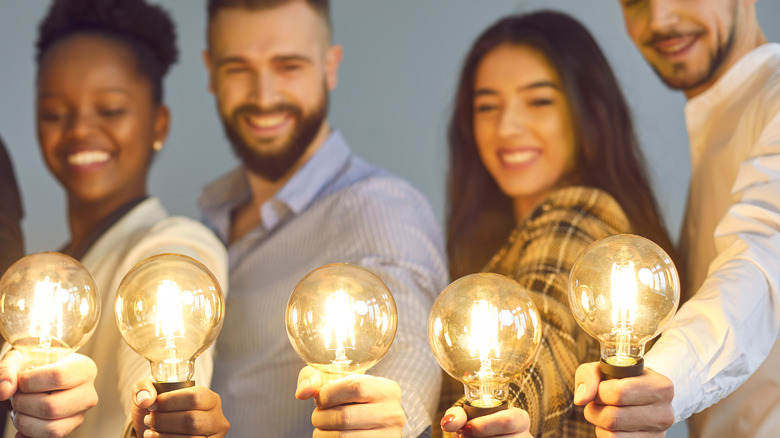 people holding light bulbs