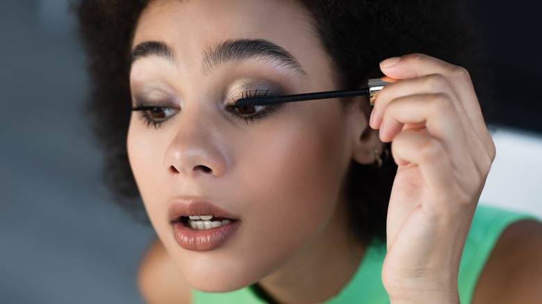 woman applying mascara