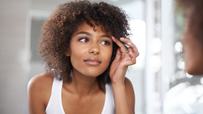 Woman looking at her eyebrows