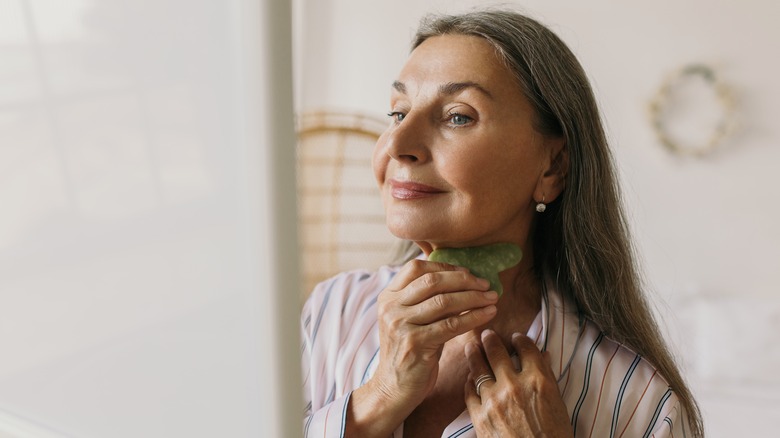 Older person using Gua Sha