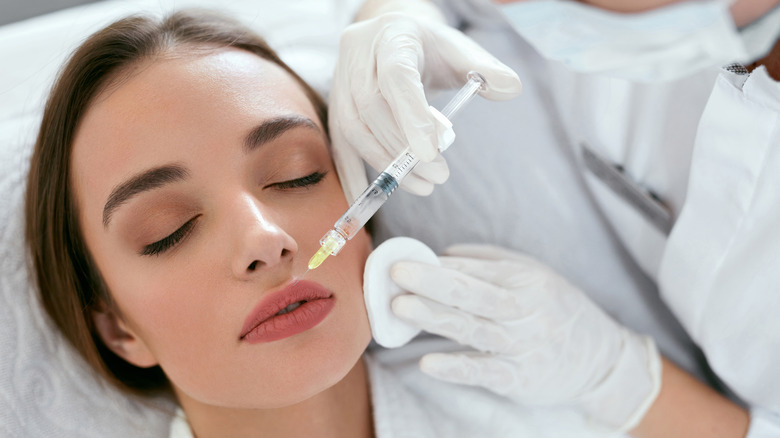 Woman getting lip injections