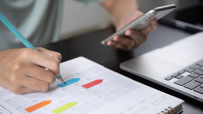 Woman writing in planner