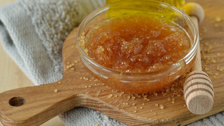 olive oil and sugar lip scrub sits on cutting board 