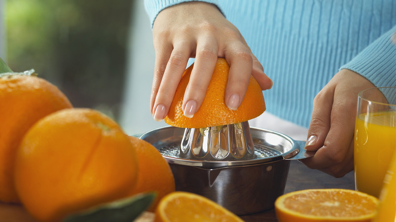 Woman juicing an orange